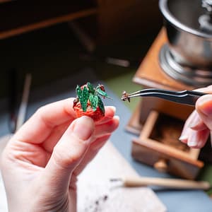 coffee grounds as plant dirt Coffee grounds are used to mimic the dirt for a miniature plant