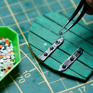repurposed diamond painting gems as screw heads Repurposing diamond painting gems to create hinges for a miniature door