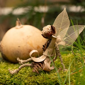 A handmade fairy with wings made of skeleton leaves in autumn setting